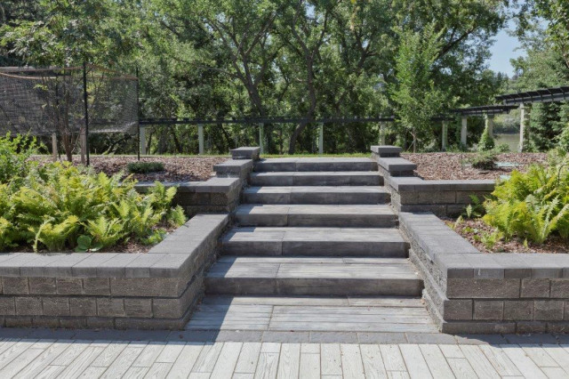 Tiered stone steps and retaining walls with planting