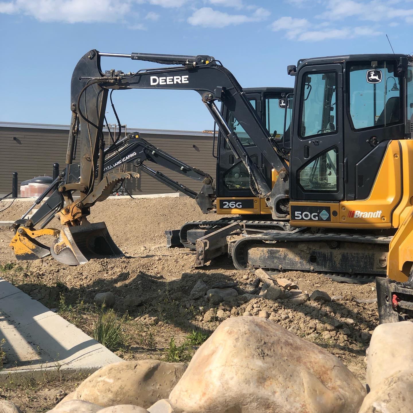 Avara Landscaping John Deere excavator working on a commercial site preparation project